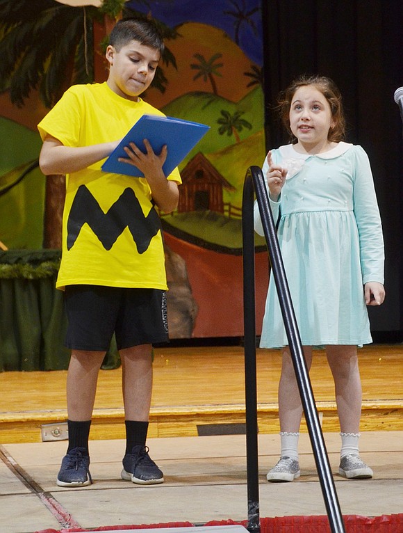 As Sally (played by Lexi Budde) dictates a letter to Santa Claus to her brother Charlie Brown (played by Gage Saresky), he tries to keep up with her vast number of Christmas wishes.