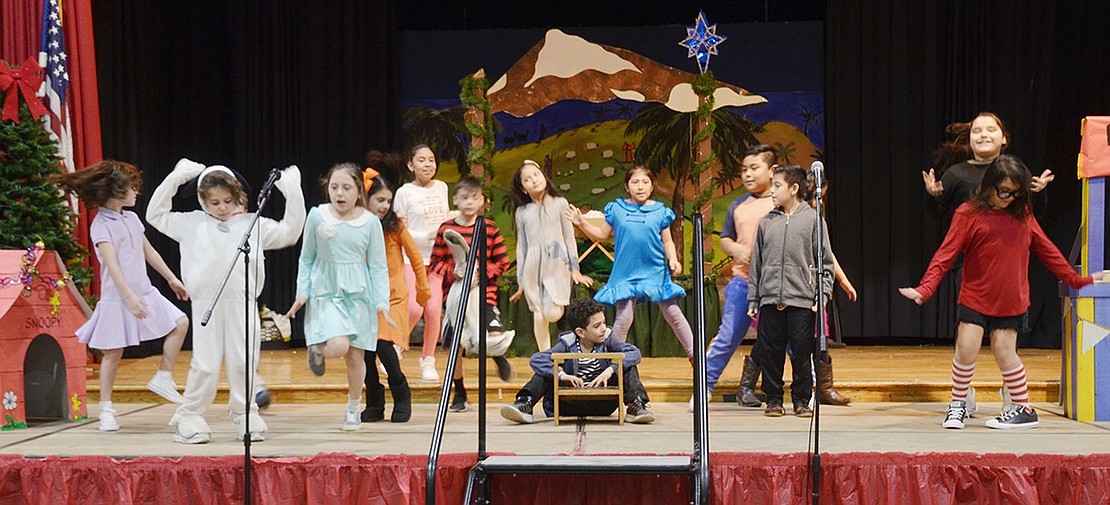 The “A Charlie Brown Christmas” cast does various classic Peanuts dances around Schroeder, played by Sergio Toledo, as he plays the piano.