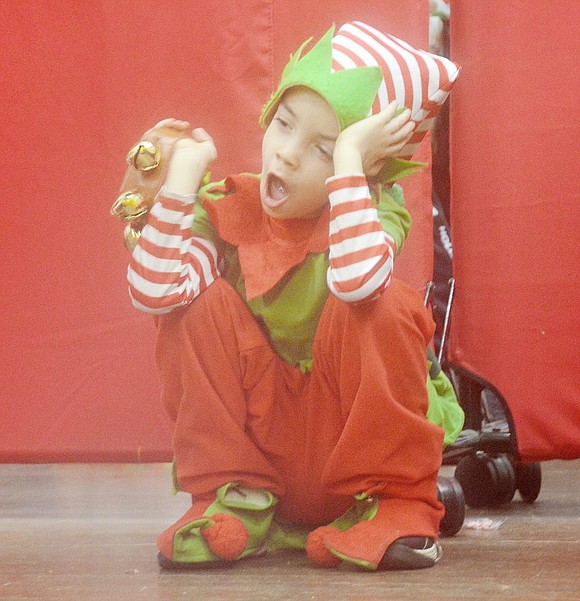 Santa’s little helper, played by Logan Massa, lets out a big yawn while jingling his bells. It was a long day for the 7-year-old, as Breakfast with Santa featured two back-to-back sessions for the first time.