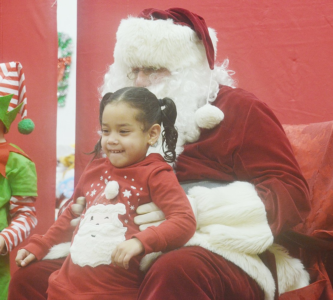 Before meeting Jolly Old Saint Nicholas, also known as Nick Mecca, 2-year-old Port Chester resident Alaysha Molina put on the perfect Santa shirt to match.