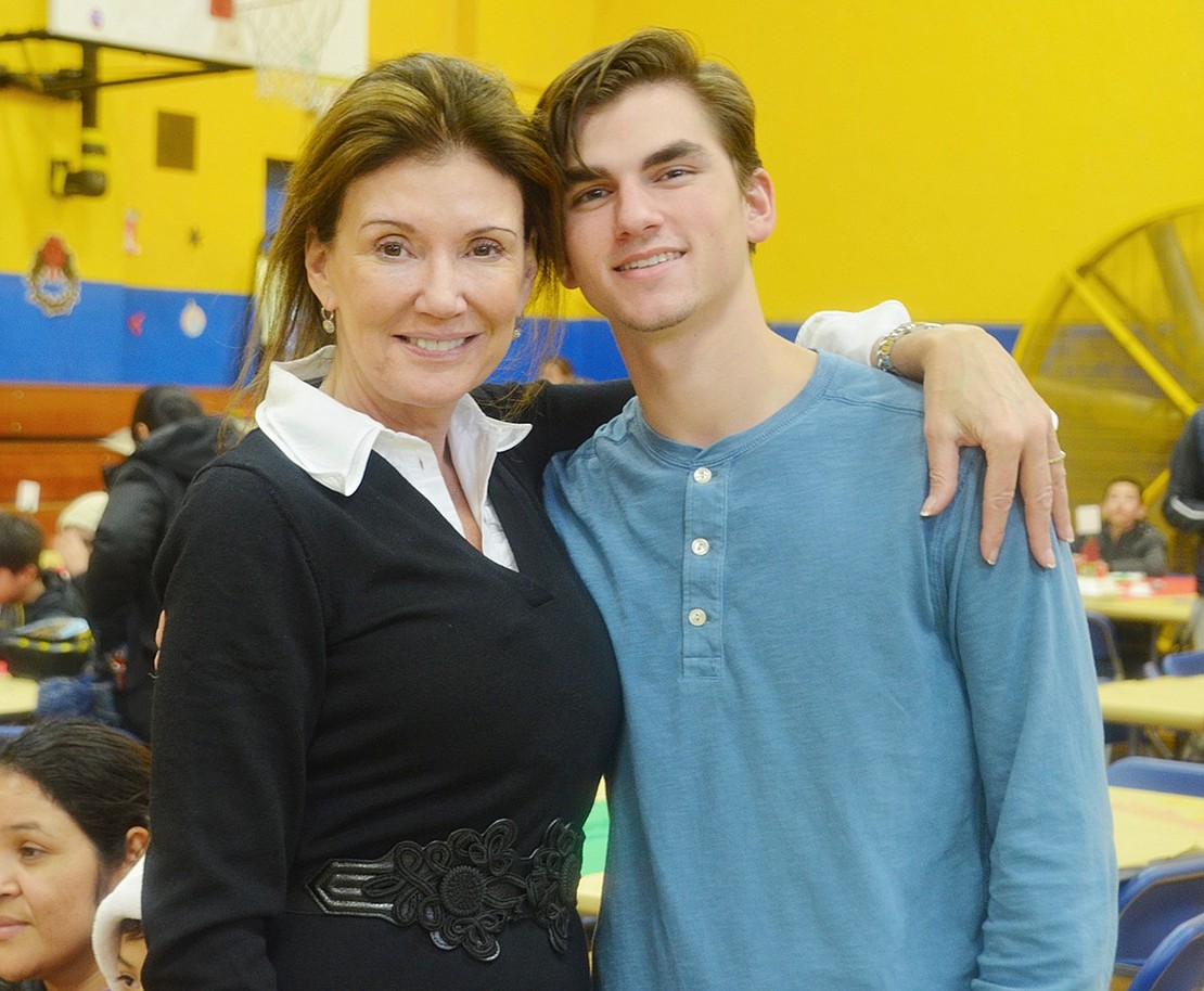 Don Bosco Center Executive Director Ann Heekin and regular volunteer Sebastian Cobb, a Riverside, Conn. resident, are so excited they were able to help around 640 children enjoy the holidays.