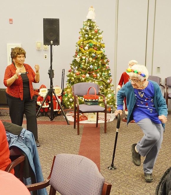 To get the Christmas party going at the Port Chester Senior Center on Grace Church Street on Saturday, Dec. 15, Port Chester resident Emma Ampuero (left) takes to the open floor to dance to “Celebration” with King Street resident Anna Strauch, who’s busily showing off her crazy moves.