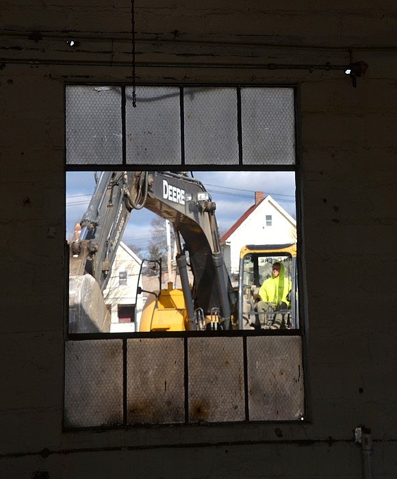 Excavator operator as seen through an open window on Friday, Dec. 7, the day work to collapse the original Rye Brook DPW buildings on the West William Street through to Ellendale Avenue site began.