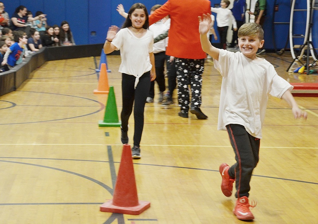 During the traditional welcoming walk to introduce all the performers, Trevor Feist flashes a big smile and waves to the crowd filling the downstairs gymnasium.