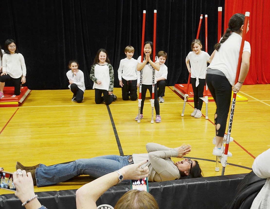 For the first time, this year a parent participated in the circus—as a surprise obstacle. Lyla Cotte feigns nervousness and pretends to need her mother Stella on stage for moral support, only to walk over her on a pair of stilts.