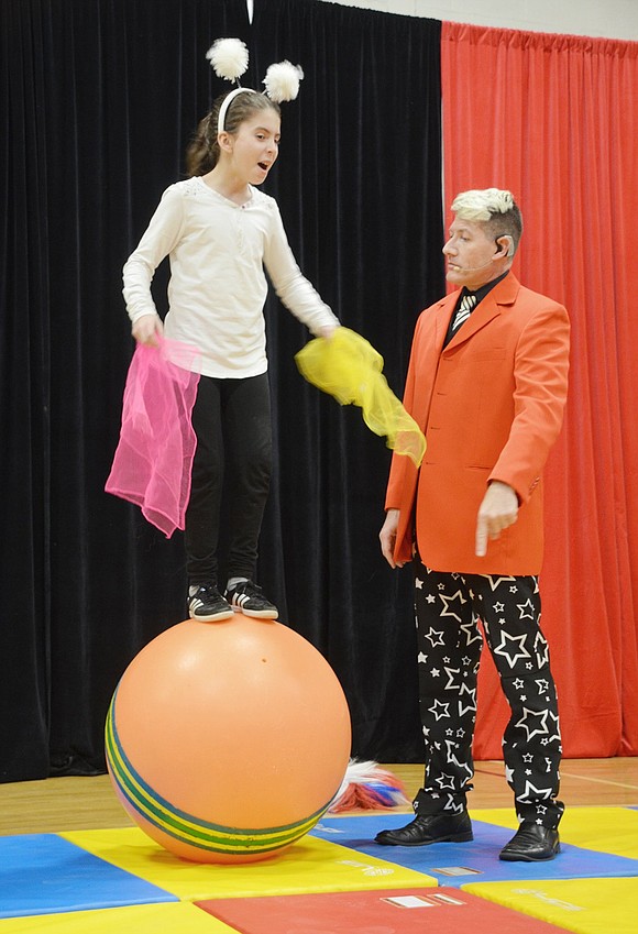 Playing a stubborn clown, Daniela Dluzhevskiy refuses the ringmaster’s order to jump off the ball. Ringmaster Doug Young is with Circus Kids Productions, the organization that’s been teaching fourth-graders stunts and tricks during their physical education classes.