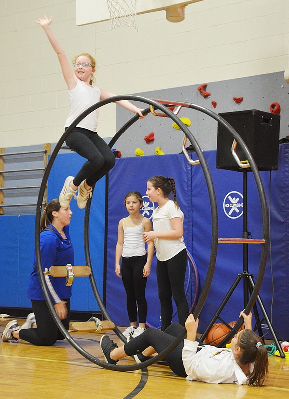 As Hannah Levine raises to the top of the German Wheel, weighed down by her partner in a seesaw-esque stunt, she dazzles the crowd with a bright smile and wave.