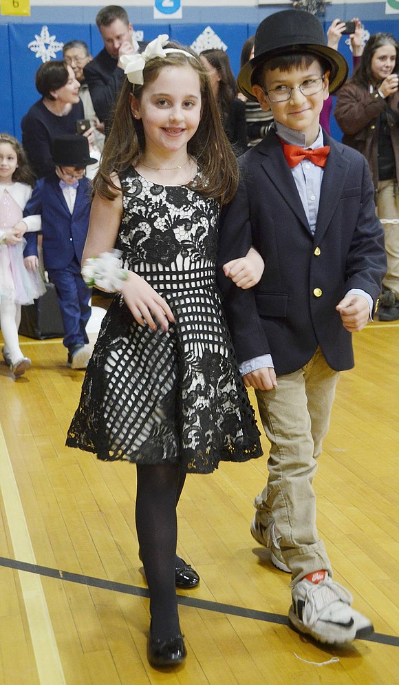 With blatant sophistication, Samantha Biderman and Lucas Shalette make their debut in a walk around the gymnasium to the “Nutcracker Suite.”