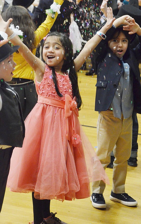 During the grand finale of singing “Frosty the Snowman,” Aria Desai gleefully tosses glitter in the air.