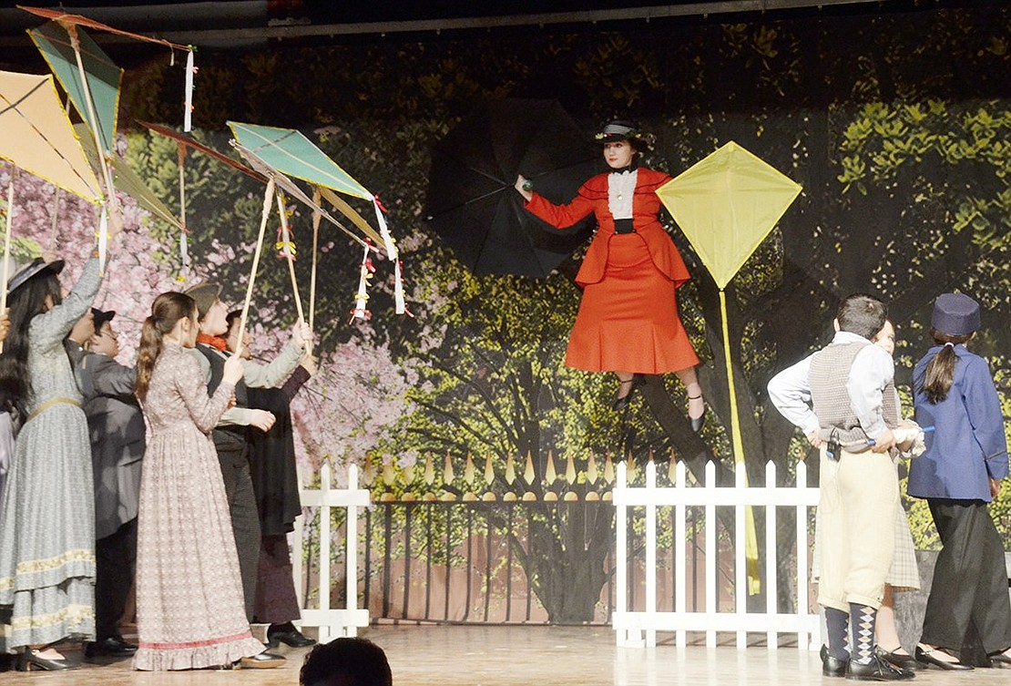 Mary Poppins, played by Gwen Dominguez, reunites with the Banks children while making a grand entrance by flight with their yellow kite during “Let’s Go Fly a Kite.” The Port Chester Middle School Drama Club students rehearse for their upcoming production of “Mary Poppins” on Tuesday, Jan. 29.
