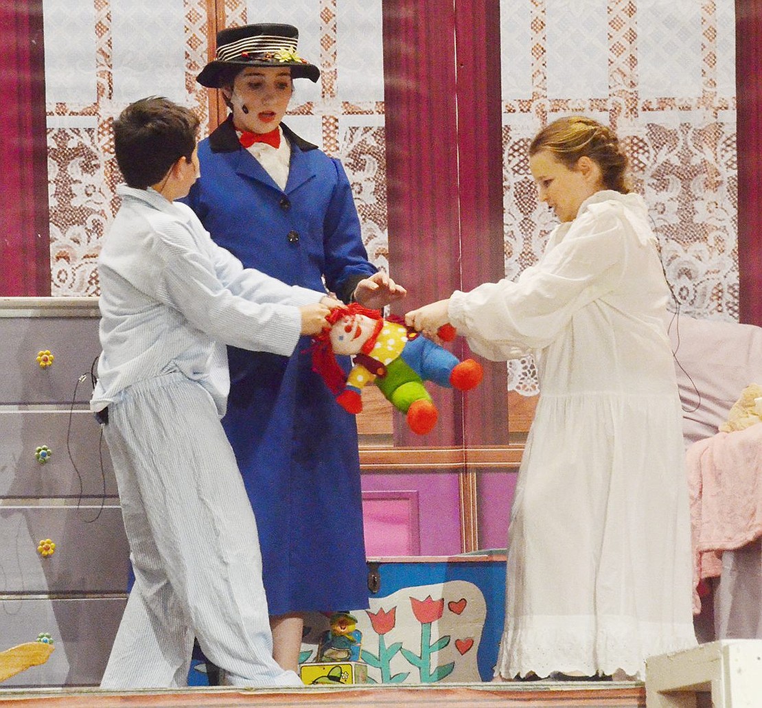 Behaving dreadfully because Mary Poppins (played by Gwen Dominguez) is taking the night off, Michael and Jane Banks (played by John Borzoni and Katherine Callaway) nearly tear apart their doll Valentine.