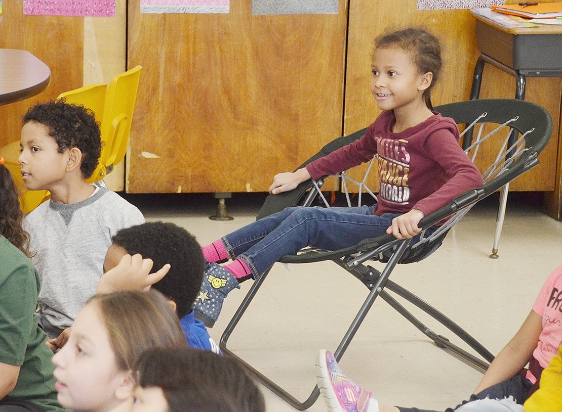 Sitting on a bungee chair in Cheryle Washington’s third-grade glass, Brianna Tyler is totally enthralled as children’s book author Roni Schotter reads “Nothing Ever Happens on 90th Street.”