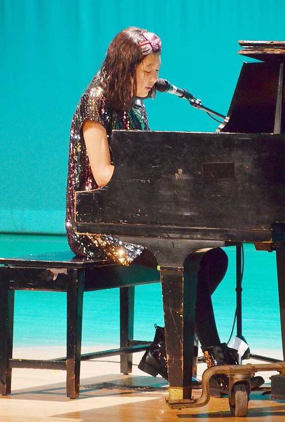 Inspired by The Hunger Games book trilogy, seventh-grader Lauren Sun sings and plays the piano as she performs her original song “Never Disappear.”