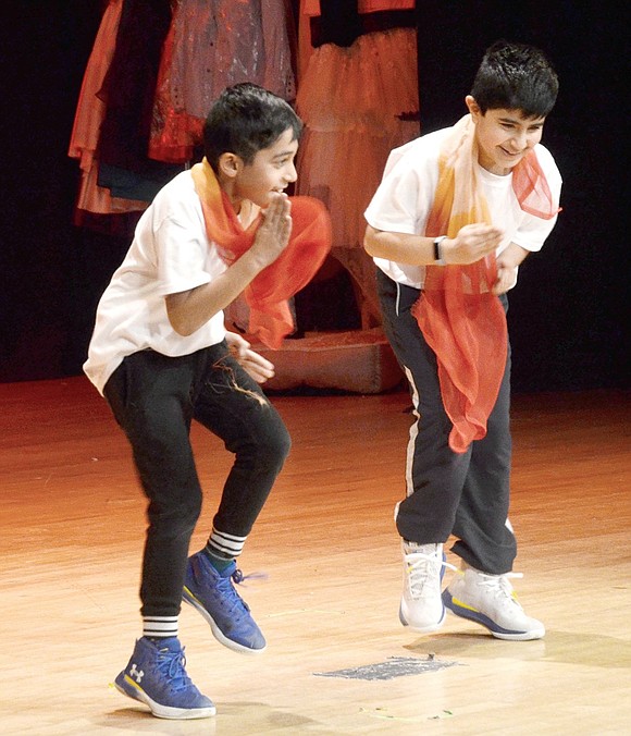 Showing the audience what hip Bollywood style dance is all about, third-grader Akshay Kumar (left) and fourth-grader Darsh Gupta show off their moves.