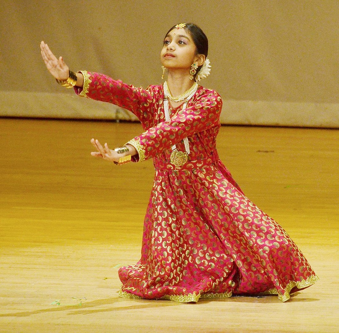 During an intricate traditional Indian Dance, Kathak, seventh-grader Kothari Kunjal uses movement to express the joys of rain. 
