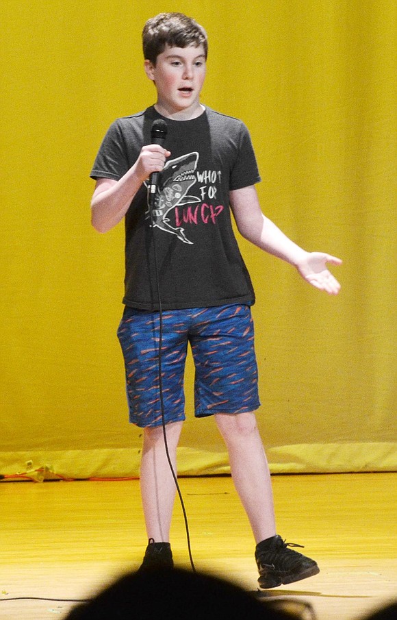 Taking a swing at stand-up comedy, seventh-grader Mitchell Cohen has the auditorium in hysterics over his grandma jokes.