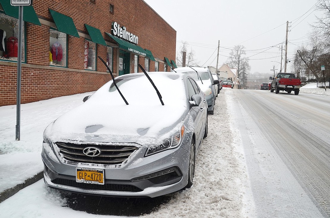 Wiper blades left up to keep them from freezing to the windshield on cars parked along North Main Street in front of Steilmann European Ladies Fashion. Jananne Abel|Westmore News 