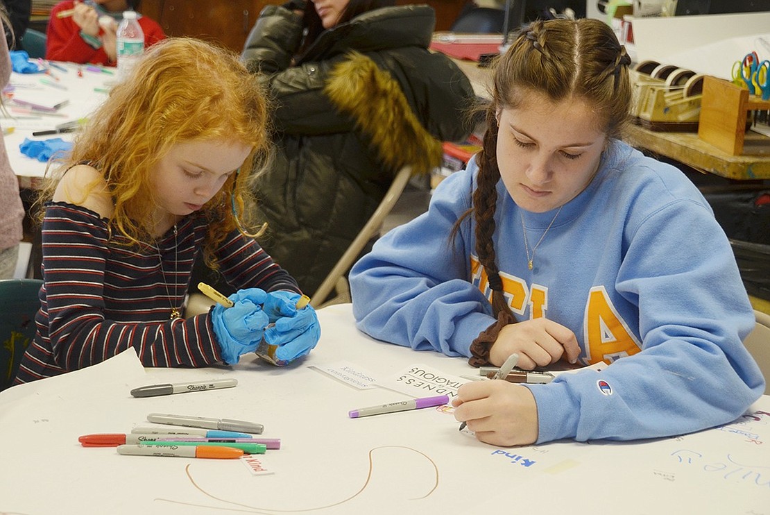 As third-grader Julia Fagan works on her rock, Blind Brook High School junior Rachel Sosin sits nearby to help inspire her with artistic ideas and words of kindness. Sosin is one of seven high school art students who spent the day at the elementary school for #MakeArtMonday.