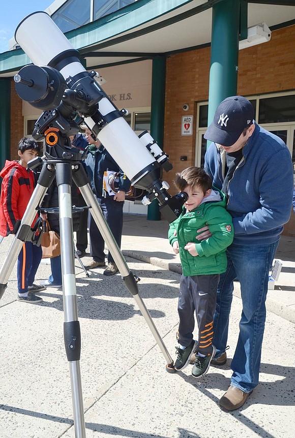 After teaching a group about stargazing tactics, Mike Lomsky lifts Ridge Street School kindergartener Michael O’Neill to show him the sky on Saturday, Mar. 23. The Westchester Amateur Astronomers affiliate gives solar demonstrations at Blind Brook High School/Middle School during CreatiCon, an annual district-wide variety showcase to celebrate creative work and educational opportunities.