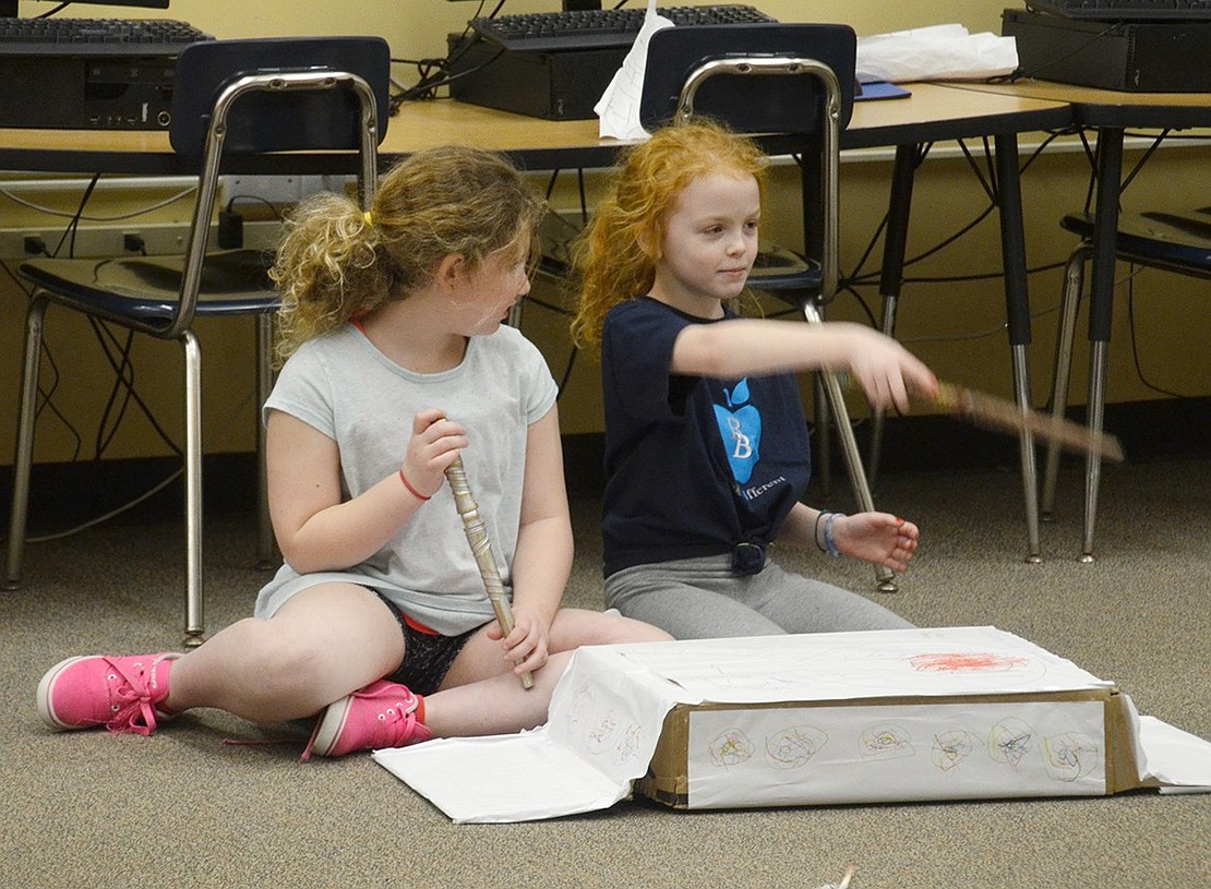 As Destination Imagination team Donut Say Impossible performs a skit about a hide-and-seek game that defies the rules of time and space in the library, Ridge Street third-graders Victoria Axelrod (left) and Julia Fagan become students at Hogwarts.