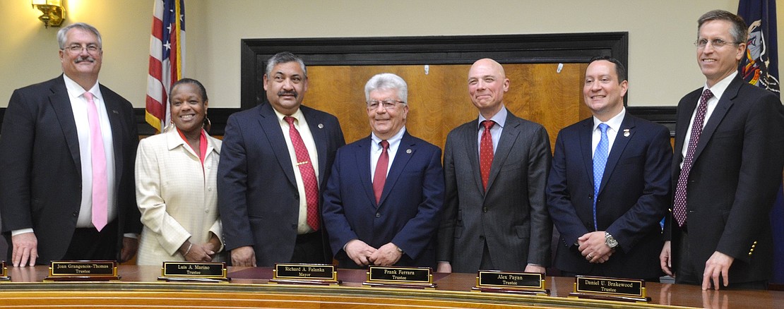 The newly-sworn-in Port Chester Board of Trustee members take their places in the village courtroom Tuesday night, Apr. 2. From left: Trustees Bart Didden, Joan Grangenois-Thomas, Deputy Mayor Luis Marino, Mayor Richard “Fritz” Falanka, Trustees Frank Ferrara, Alex Payan and Dan Brakewood.
