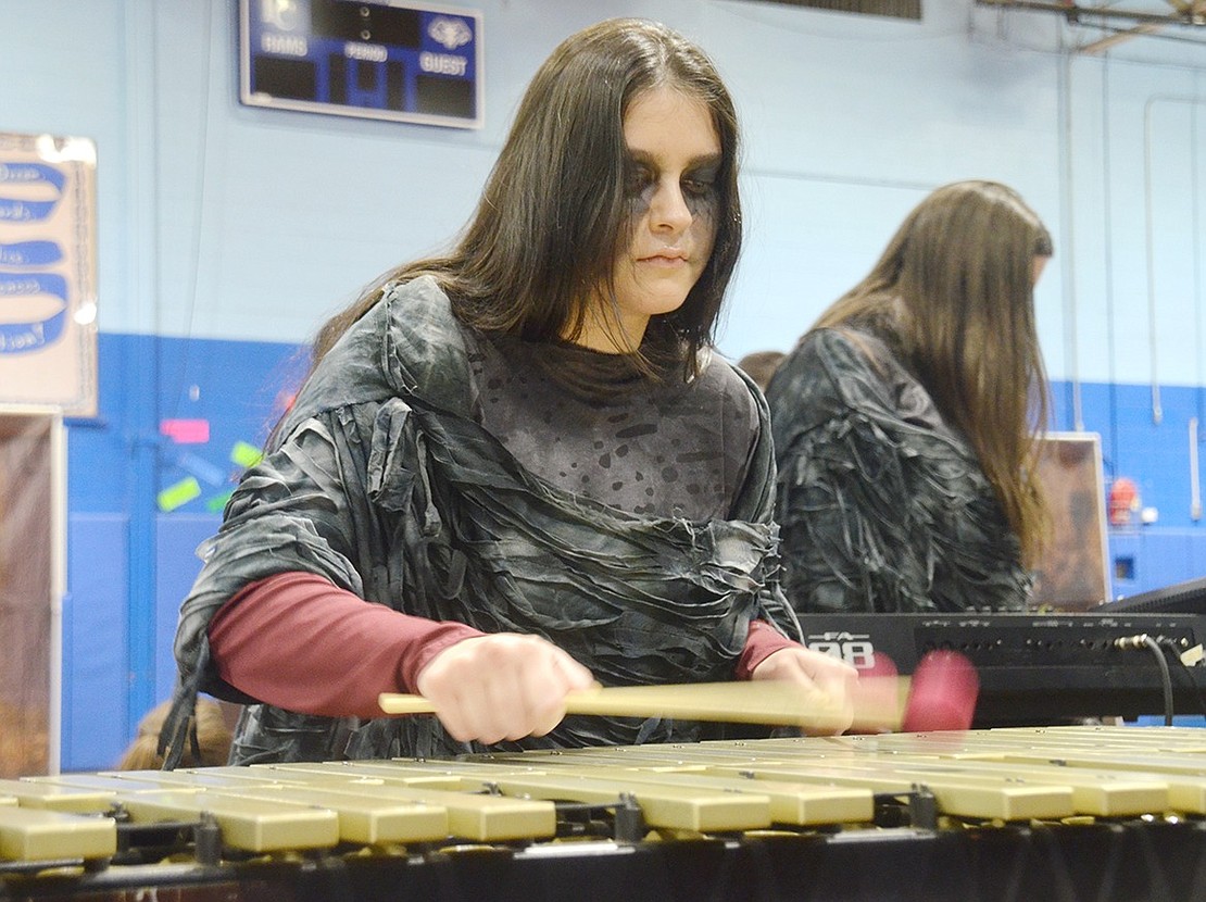 Despite her scary makeup for the Winter Percussion show, high school senior Alondra Gamez makes beautiful music on the vibraphone.