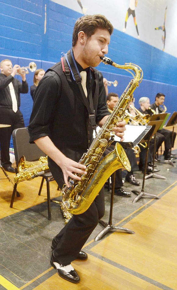 As the jazz band provides showy tunes in between other performances, senior Ryan Heffernan spouts a groovy solo on the baritone saxophone.