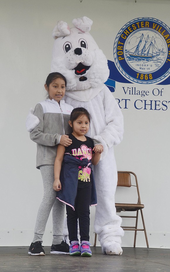Port Chester Middle School sixth-grader Ana Hernandez takes her 5-year-old sister Beatrize onto the stage so they can pose for a sweet photo together with the Easter Bunny.
