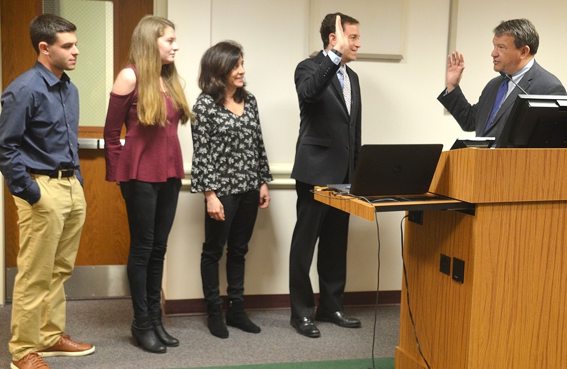 County Executive George Latimer swears in Paul Rosenberg for a third three-year term as mayor before the Rye Brook Board of Trustees meeting on Monday, Apr. 15. He is accompanied by his wife Debby and twins Julia and David.