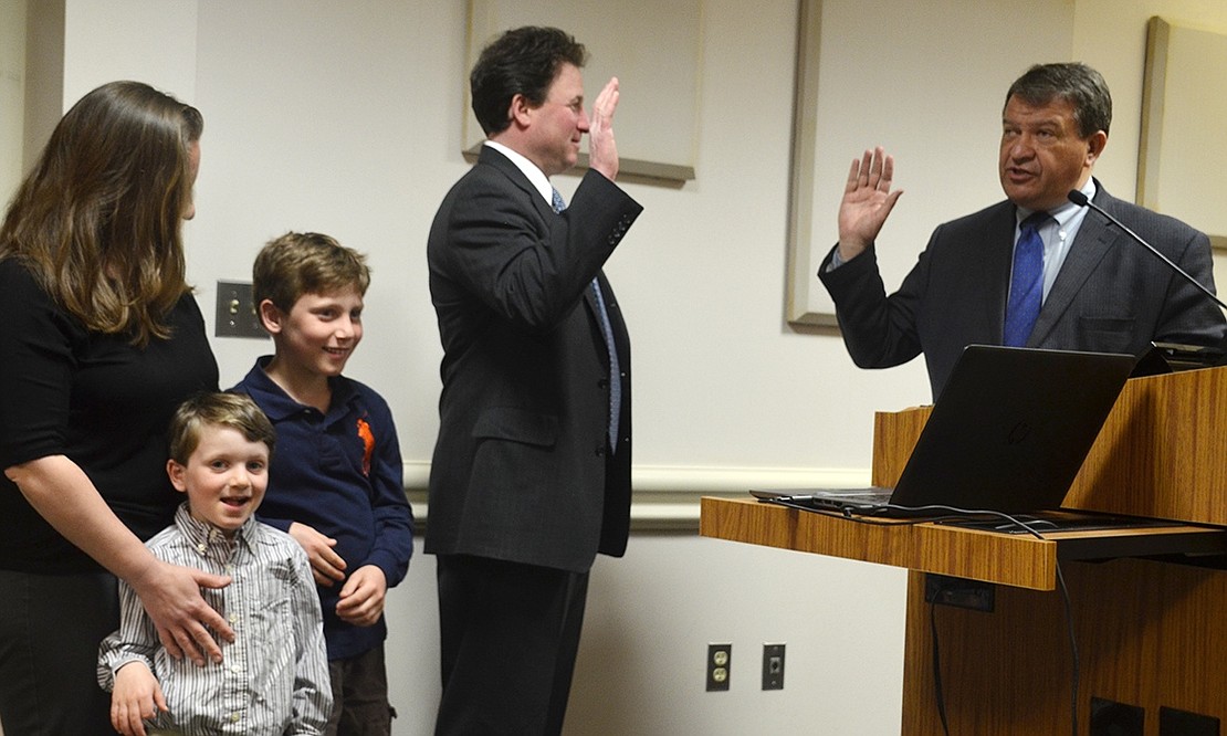 Jason Klein swears to uphold the laws of the State of New York and the Village of Rye Brook in taking the oath of office for a third three-year term as trustee. His wife Judy and sons Alexander and Elliott share the limelight.