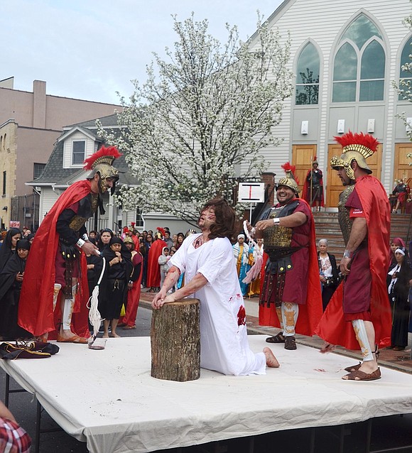 Romans flog Jesus in front of Holy Rosary Church at the first Station of the Cross where he is condemned to death during a professional reenactment of the Way of the Cross on Good Friday, Apr. 19. It ended at Corpus Christi Church on South Regent Street.