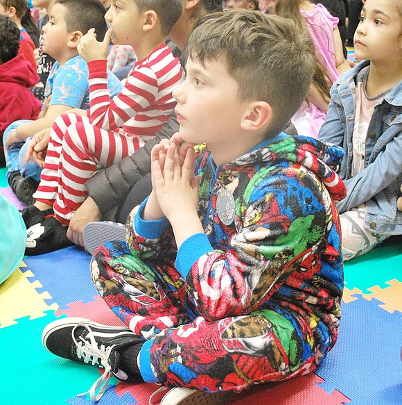 As wild as his warm superhero onesie looks, Park Avenue Elementary School first-grader John Giordano is perfectly calm and totally captivated by the tales being read aloud.