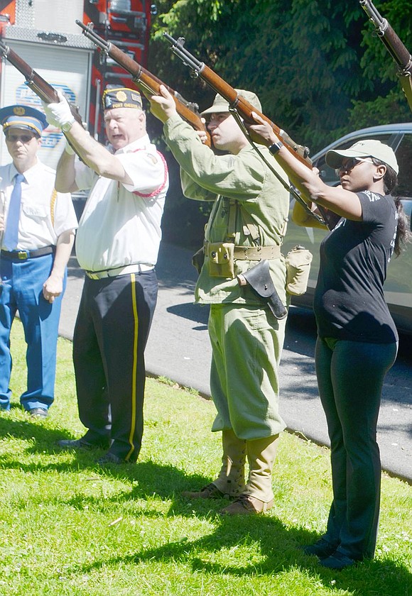 Longtime Port Chester Post 93 Firing Team member Ken Neilsen, World War II reenactor and Port Chester volunteer fireman Jonathan Mazzella and Carleen Ybarra, a 22-year veteran of the U.S. Army Civil Affairs Battalion and a Rye Brook resident, fire shots during the ceremony at the Korean War memorial at the entrance to Crawford Park on Monday, May 27.