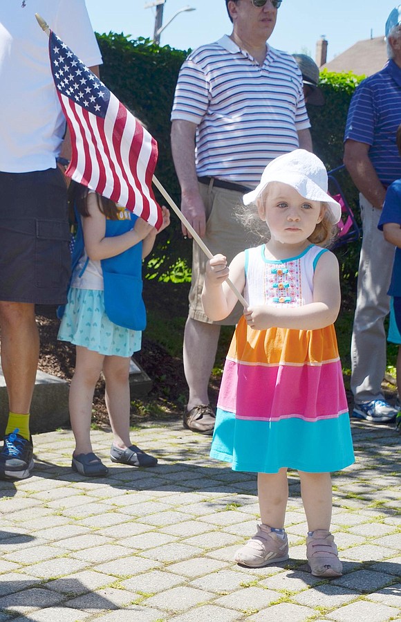 Ryan Allen, 2½, of Port Chester, waves her American flag as she listens to speakers during the main Memorial Day ceremony at Veterans’ Memorial Park on North Regent Street.