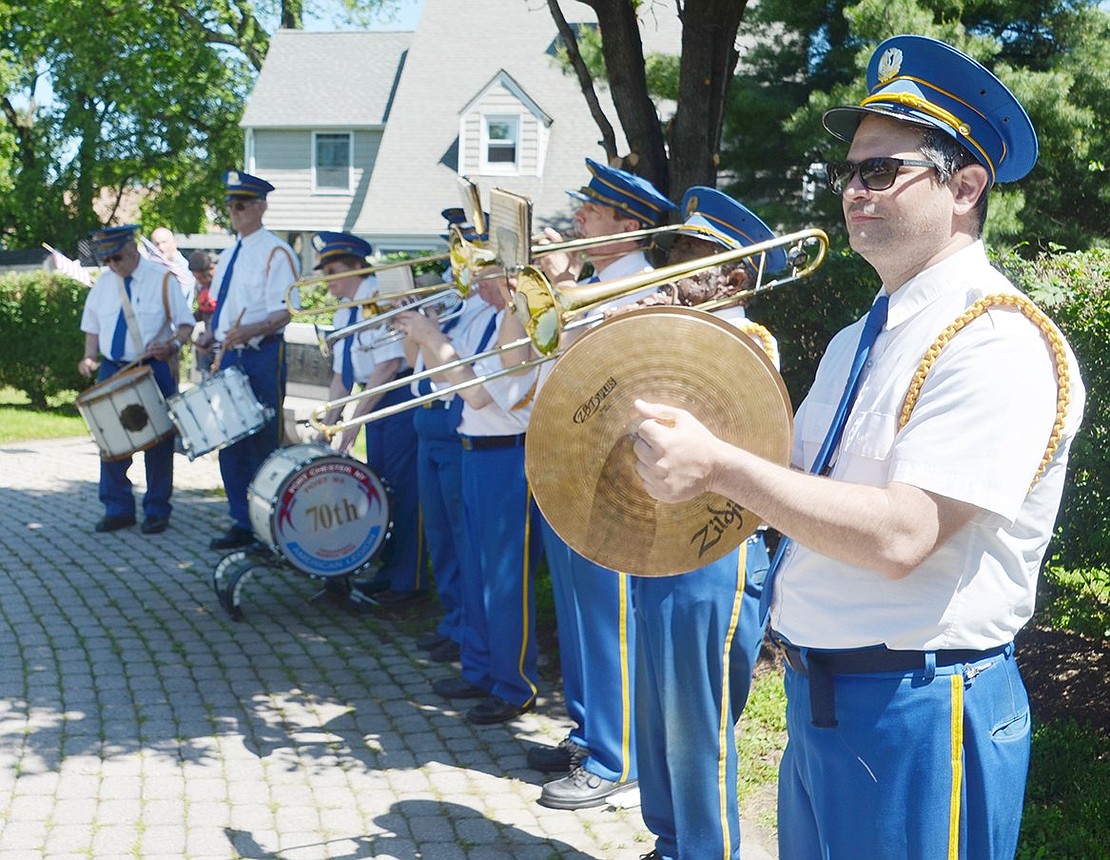 As the Port Chester American Legion Band plays patriotic tunes at Veterans’ Memorial Park, White Plains resident Renato Baptista stands at the edge of the formation and taps his cymbals.