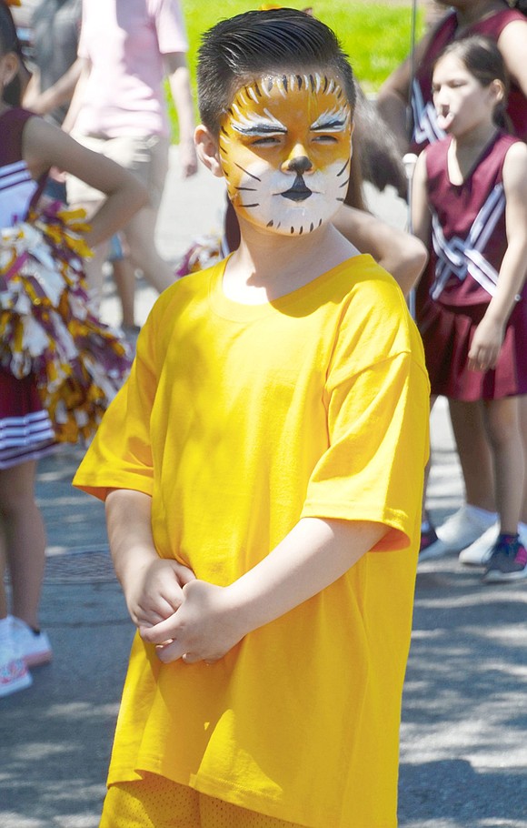 As he marches with his peers, King Street School third-grader Dominick Becerra takes his role as the lion mascot very seriously.