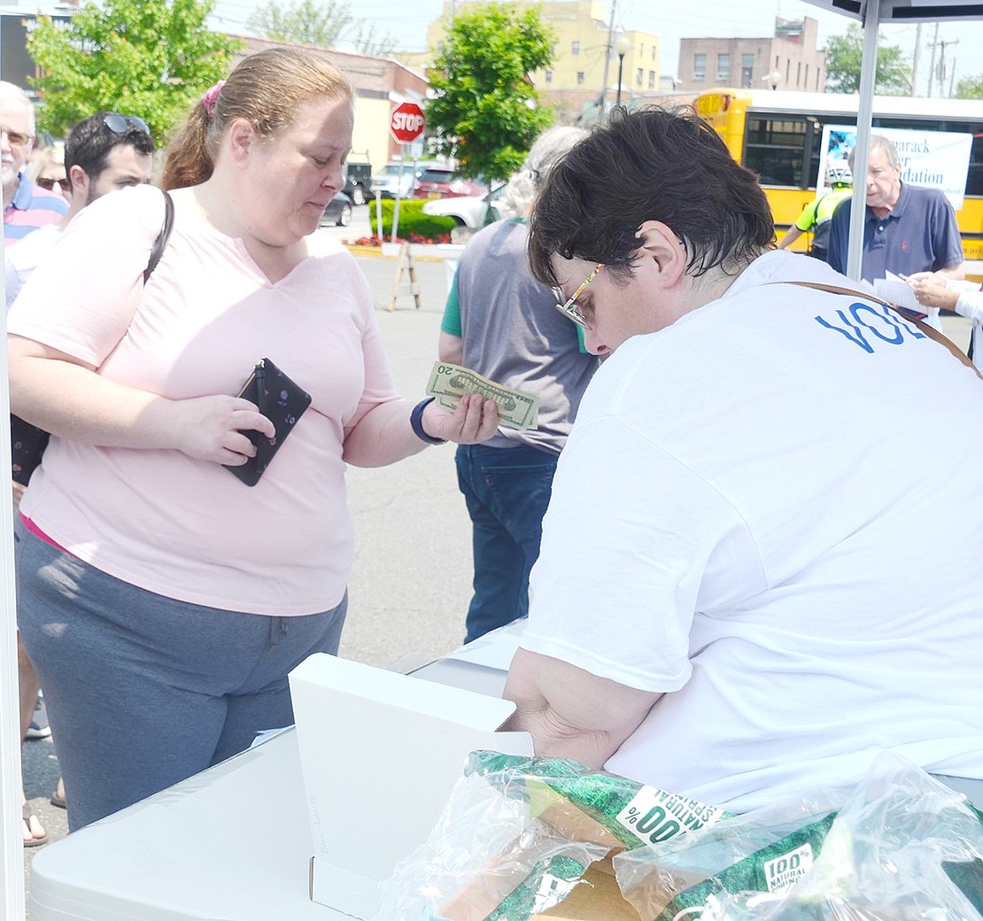 Rye resident Christine Iarocci (left) does a quick count of her cash before purchasing Taste of Port Chester tickets from Tamarack Tower Foundation board member Denise Quinn in the Marina Parking Lot.