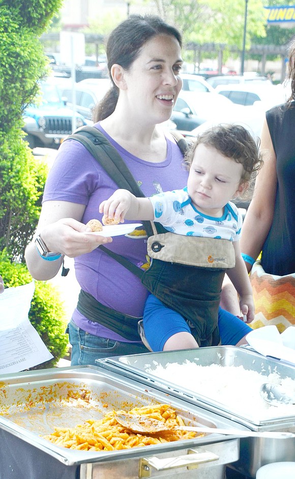 There’s no time for pleasantries when yummy food is in the mix. While White Plains resident Dana Greenstein chats with Copacabana staff, her 1-year-old son Michael grabs the cheesy bread ball on her plate.