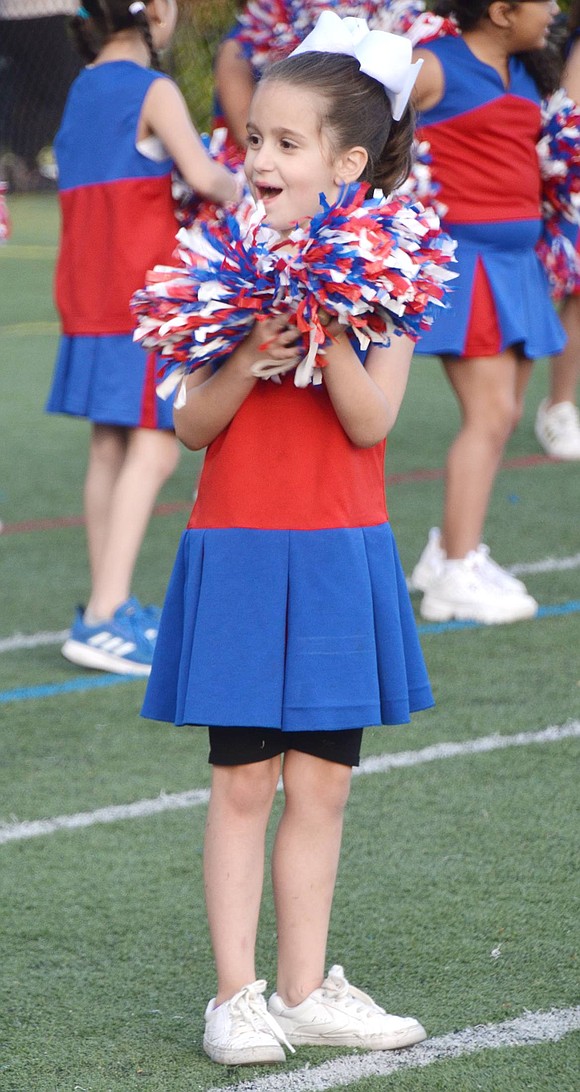 Park Avenue School first-grader Gianna Carpenteri boisterously giggles at her unpictured friends during the cheerleader warmups.