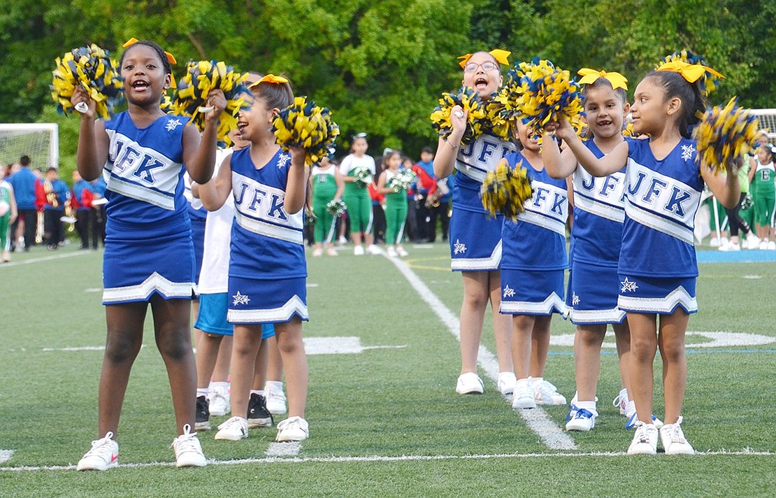 Fronting two lines of Kennedy School cheerleaders doing their routine to a ’90s throwback mix, first-grader Camila Juarez (right) looks to confident first-grader Keily Arroyo for reassurance.