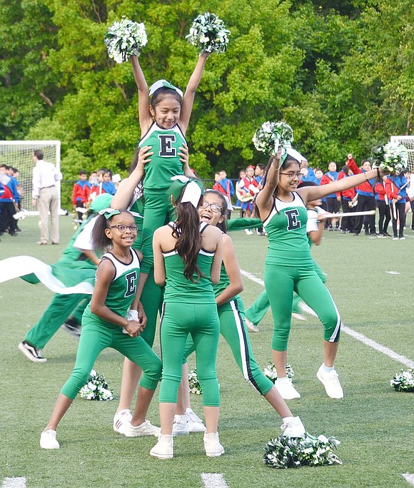 Second-grader Jaimy Pulla shines high with a huge grin as her fellow cheerleaders lift her up at the end of the Edison School spirit team routine.
