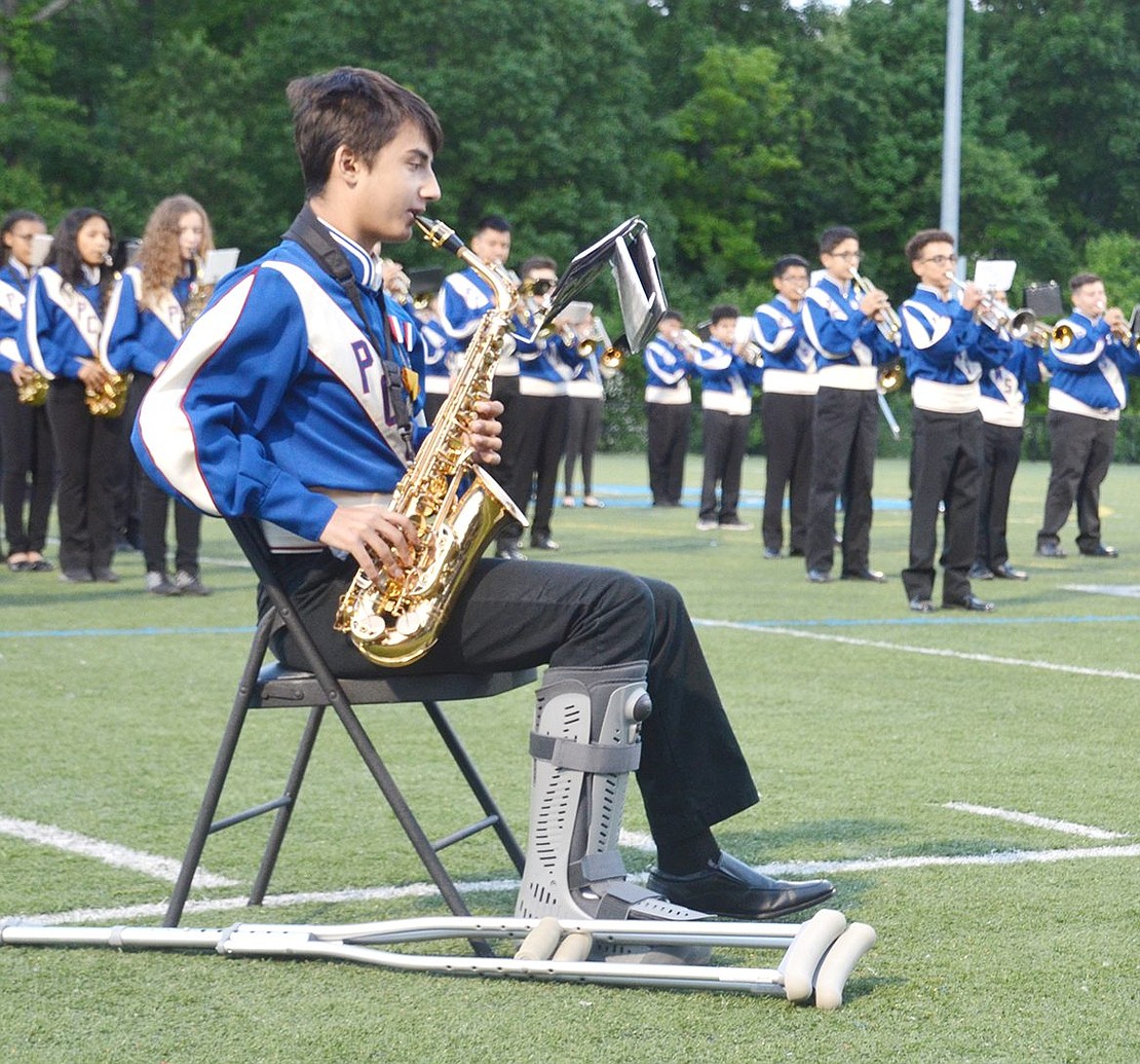 A leg injury doesn’t stop seventh-grader Orhan Eski from joining his Port Chester Middle School bandmates on the Purchase College field with his saxophone.