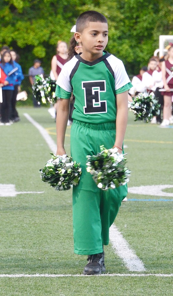 With a suave strut, Edison School second-grader Jason Rivera walks onto the football field to perform in the spirit squad’s end of the year show.