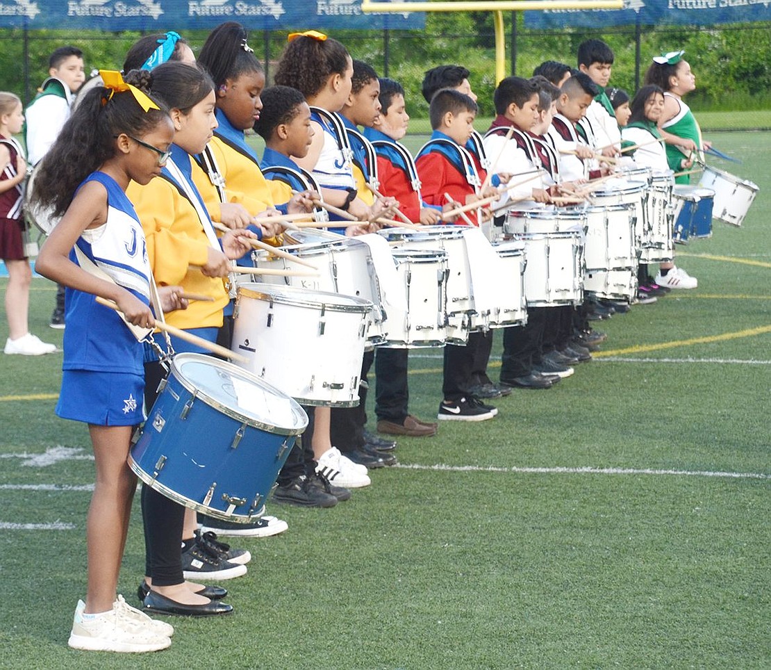After the elementary school bands mix for their grand performance together, JFK School fourth-grader Faith Adamson beats her snare on the edge of the drumline.