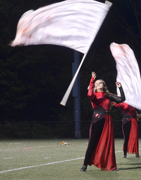 On the right side of the field, high school freshman color guard member Angelia Fallanca tosses her flag in the air during the final “Alma del Bailador” show.
