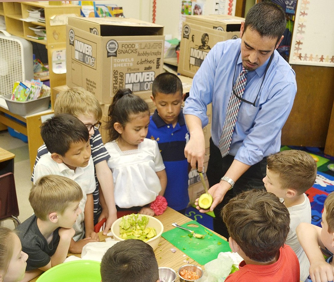 Food is the tastiest part of culture. Park Avenue School first-graders in Marianne Scofield’s class gather around Port Chester School District Director of Bilingual Programs Felipe Orozco as he gives a guacamole-making demonstration. A vast array of cultural activities swept the whole school for Global Citizen Day on Tuesday, June 11, a celebration aligning with the One World curriculum encouraging students to share their family heritages. Sarah Wolpoff|Westmore News 