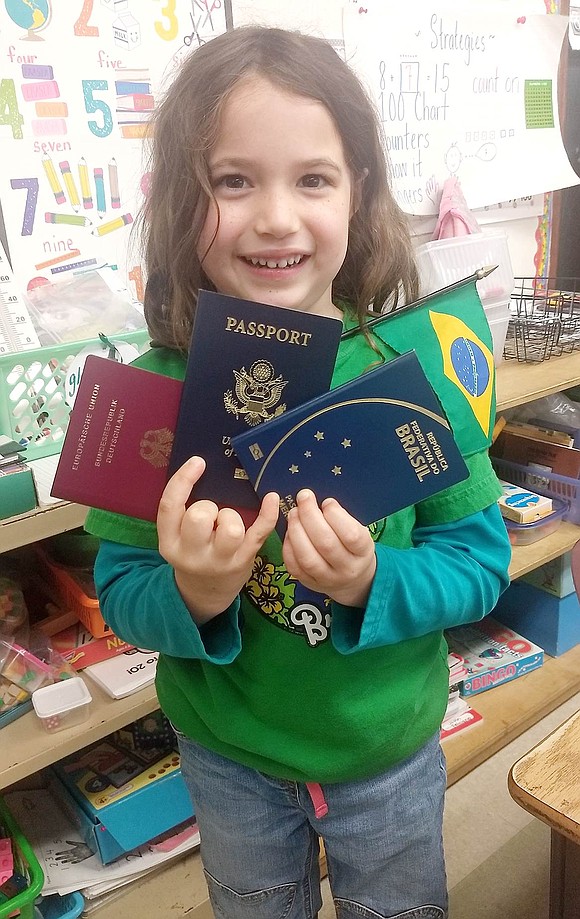 Global Citizen Day is about celebrating diversity in student heritage, and first-grader Eve West Zywottek has three nationalities to show off! The first-grader proudly holds up three passports in her name—from Germany, the United States and Brazil.