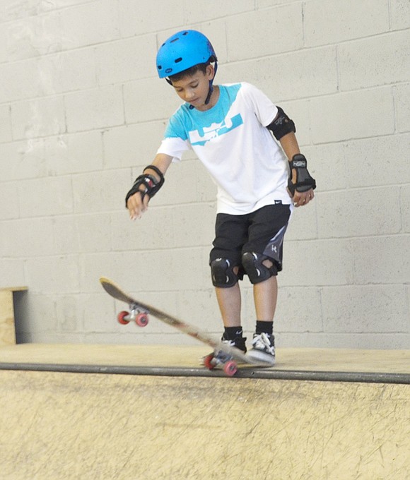 Ready to go in his protective padding and helmet, 12-year-old Daniel Martello practices ways to get started on the halfpipe inside a private skate park on Wilkins Avenue on Saturday, June 22. The rising Port Chester Middle School seventh-grader is one of dozens who spent the afternoon skating at a fundraising event organized by Port Chester Police Officer Ken Manning in his efforts to bring a Port Chester Skate Park to the Village.