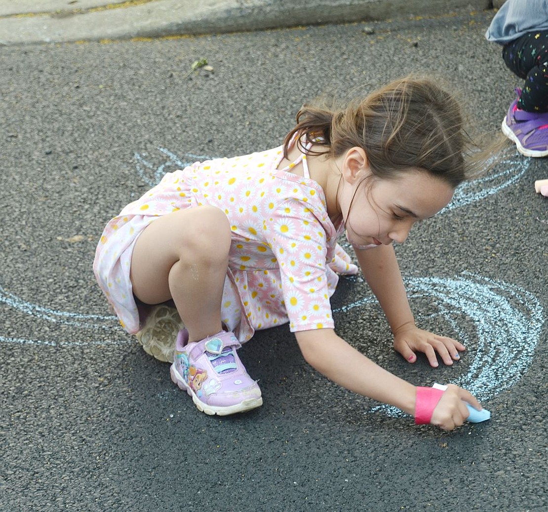 With the street blocked off in front of the skate park, Wilkins Avenue makes a great canvas. Lia Manning, the 4-year-old daughter of Port Chester Police Officer Ken Manning, who envisioned the idea of a Port Chester Skate Park, shows off her creative mind with a piece of blue chalk.