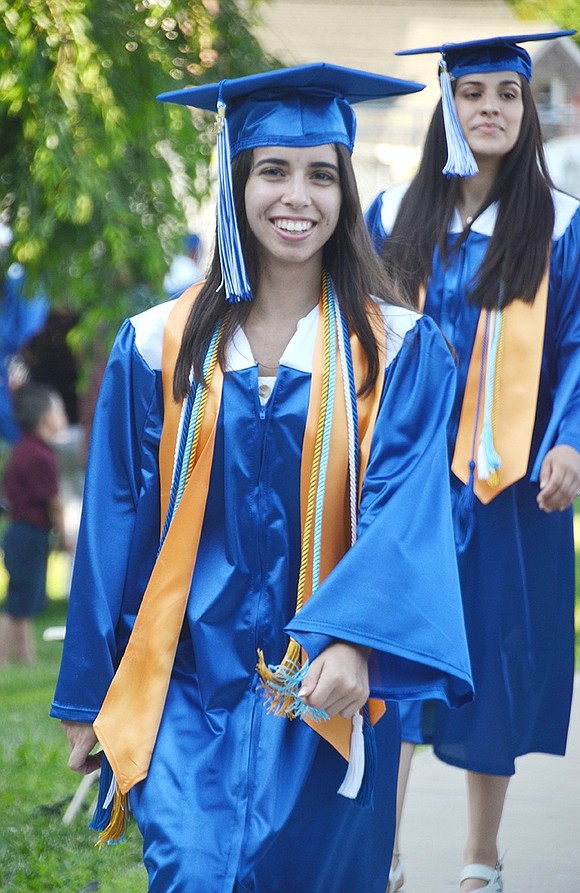 With honor cords around her neck and a beaming smile across her face, Jalissa Pirro walks to her seat as “Pomp and Circumstance” resonates.